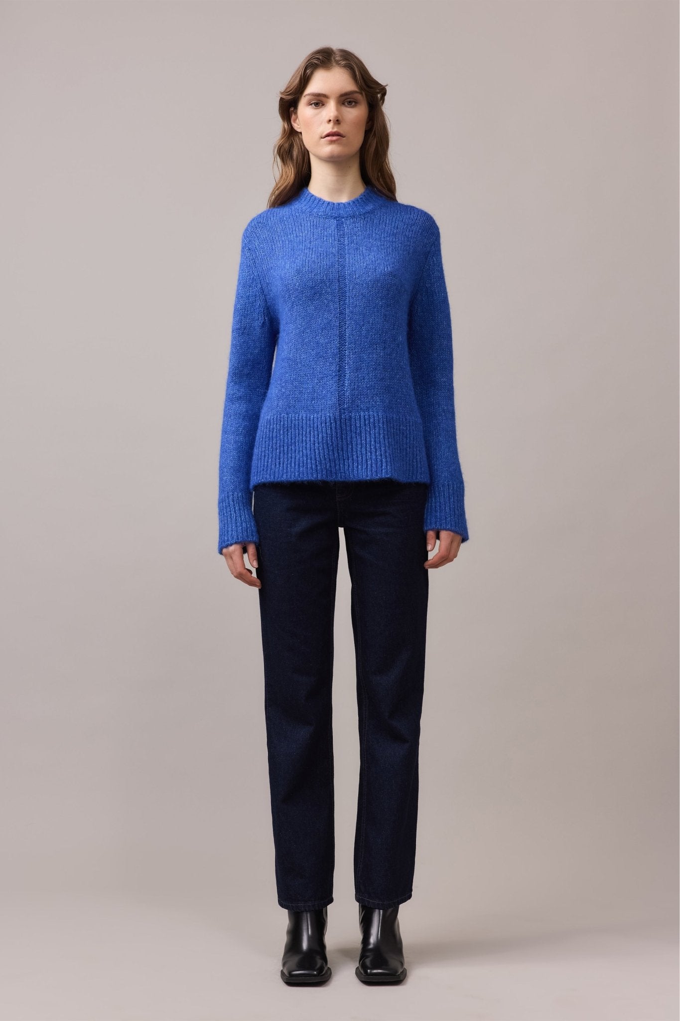 Front view of a woman in the Alfie Lofty Knit in cobalt blue, showing the relaxed crew neckline and subtle dropped-stitch detail.