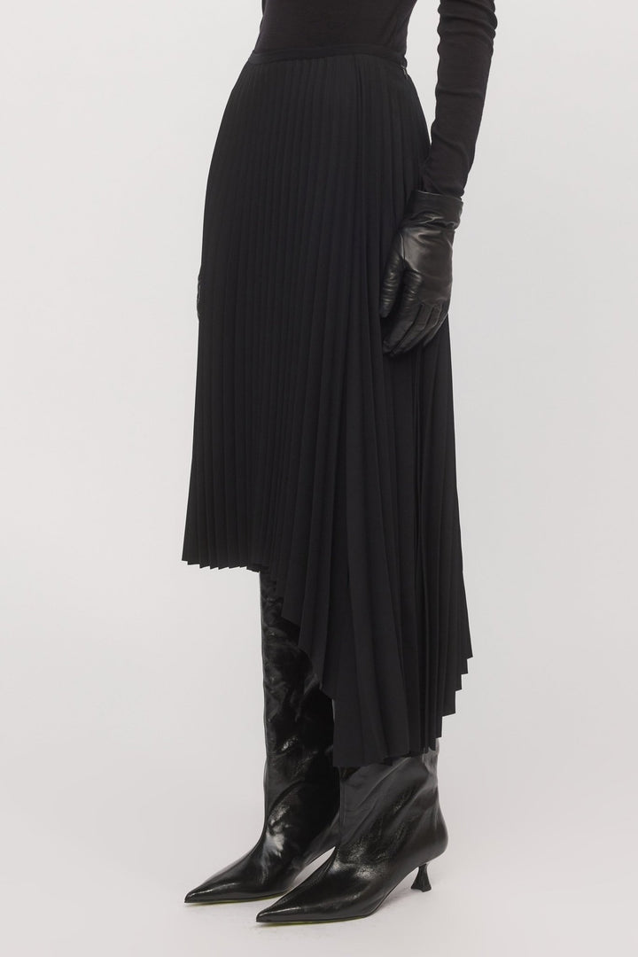 Side hem detail of Asymmetric Pleat Skirt – showing drape, pleats, and asymmetrical cut.