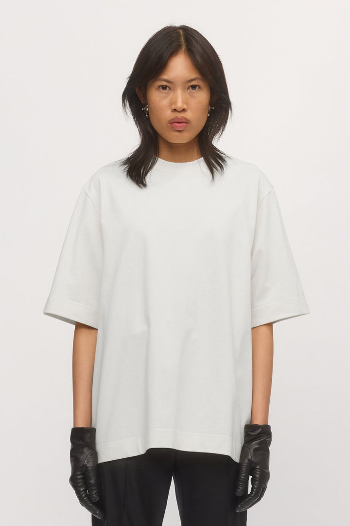 Close-up front view of woman wearing Boyfriend Tee in White – ribbed crew neck and oversized cut visible.