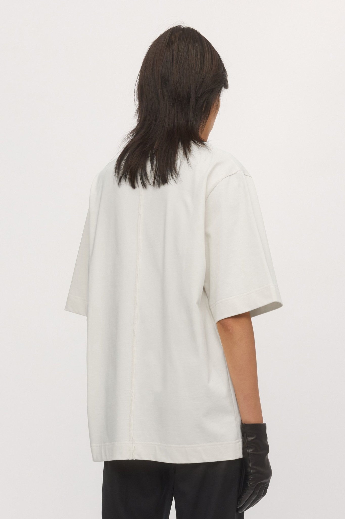 Close-up back view of White Boyfriend Tee – showcasing soft cotton jersey fabric and relaxed drop-shoulder design.