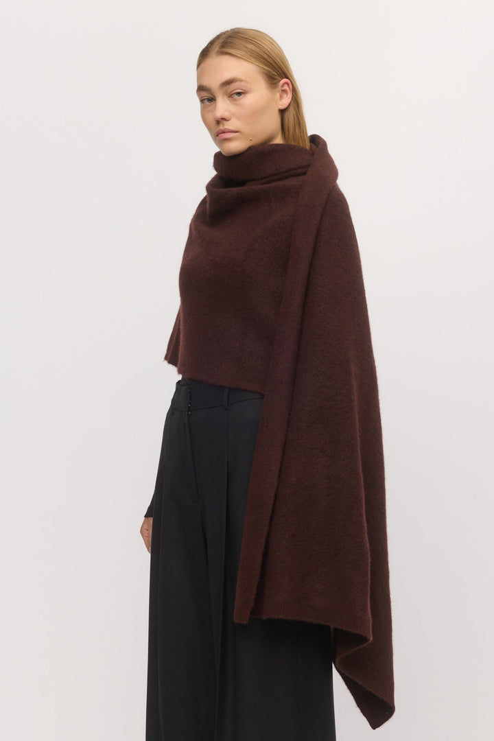Side angle of woman in Brushed Anywhere Wrap Mahogany – deep brown wool-cashmere wrap with cozy brushed finish layered over a black outfit.