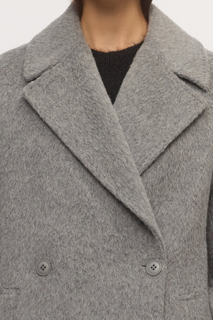 Detail of Drop Shoulder Coat neckline and lapels in textured wool, shown in metallic colour โ Skin and Threads