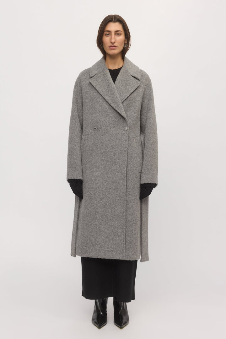 Front view of woman wearing Drop Shoulder Coat in metallic grey wool with oversized notch lapels and relaxed silhouette โ Skin and Threads