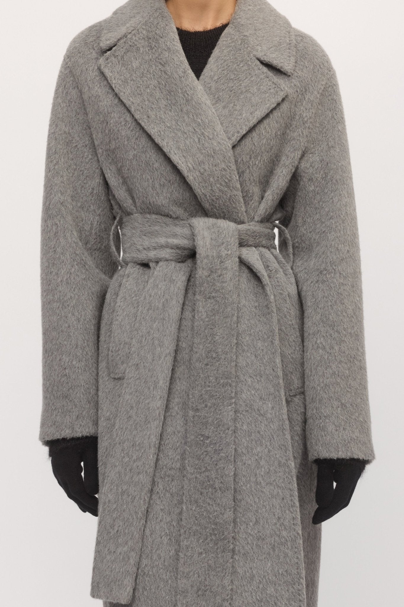 Close-up of belted Drop Shoulder Coat in metallic grey wool, showing texture and wrap detail โ Skin and Threads