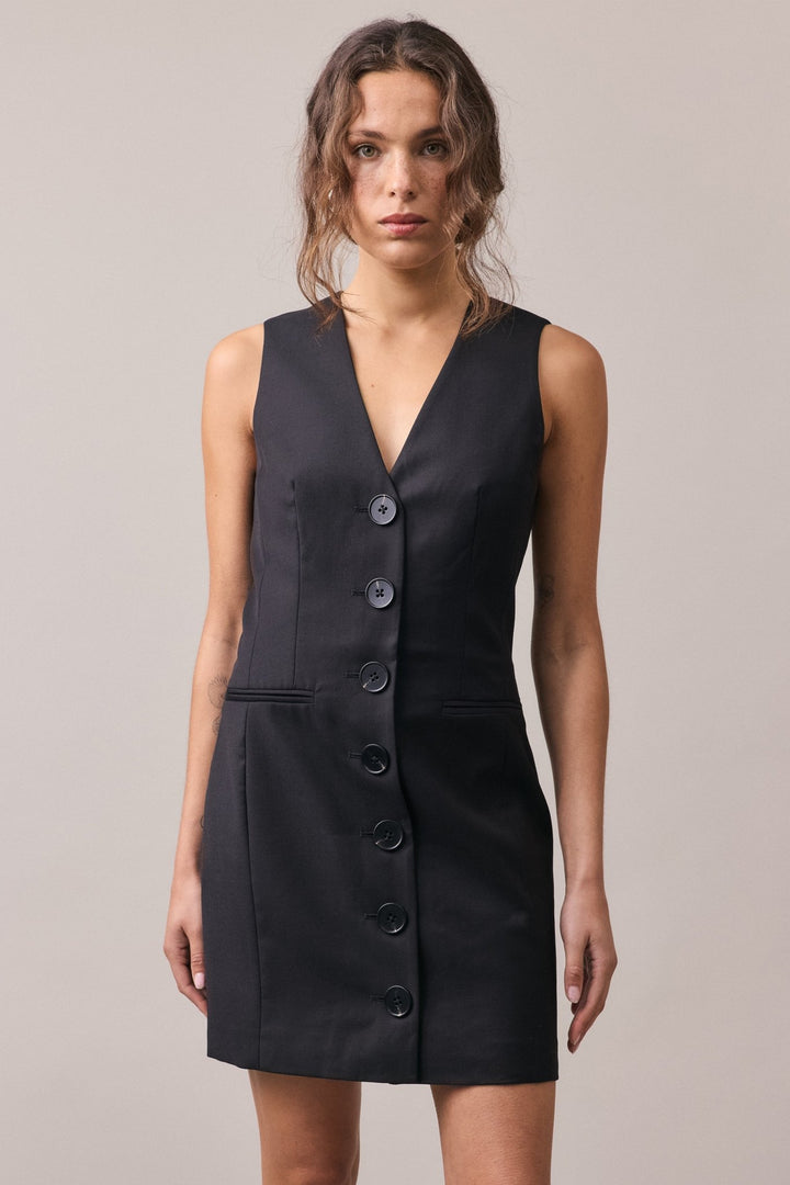 Close-up of the black Havana Tailored Dress, showcasing the statement buttons and precise tailoring.