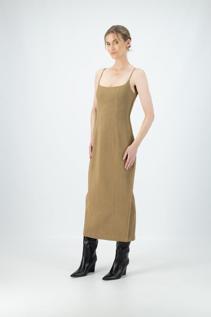 A woman is wearing a brown midi dress with thin straps.