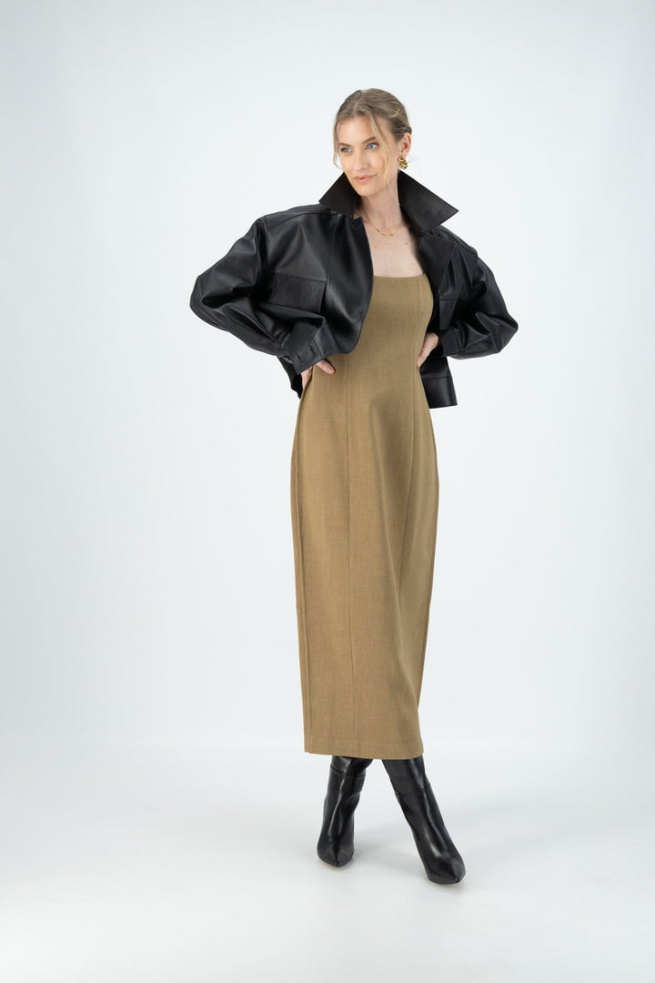 A woman is wearing a Kiana midi dress styled with black oversize leather jacket and leather boots.
