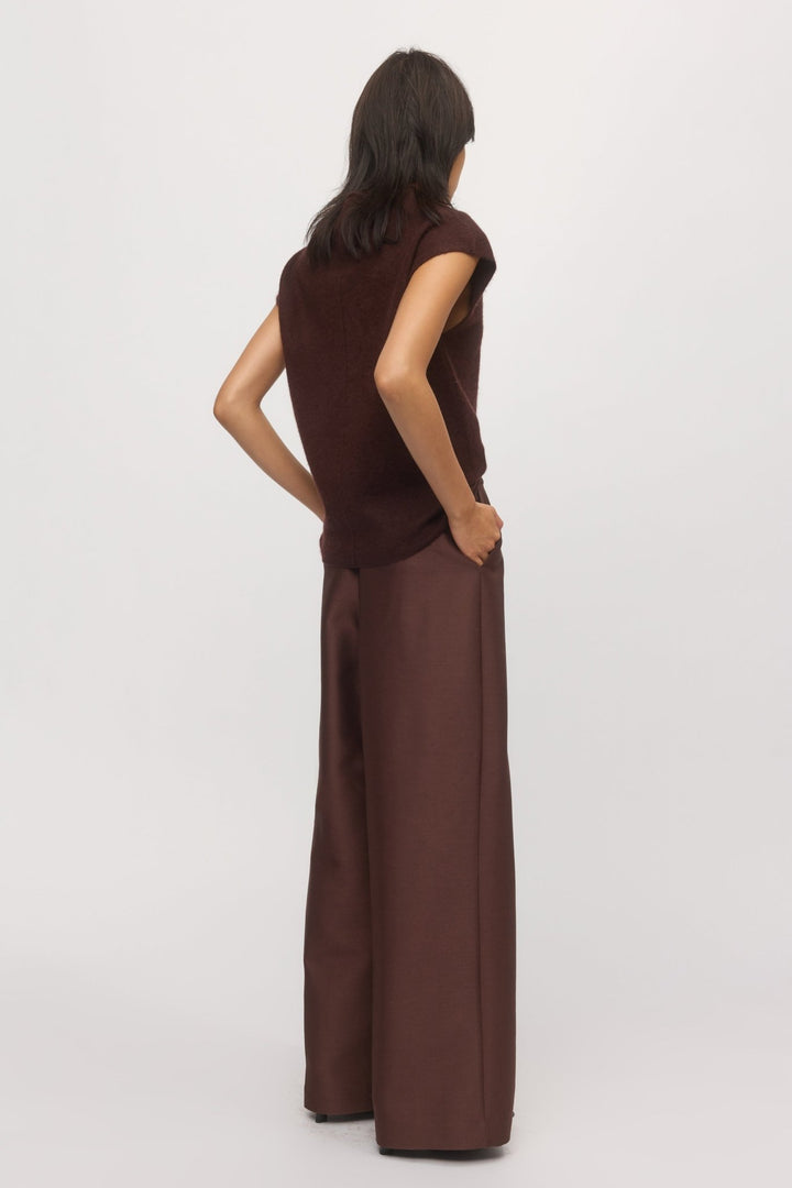 Back view of a woman is wearing knit tank in mahogany paired with wide-leg pants.