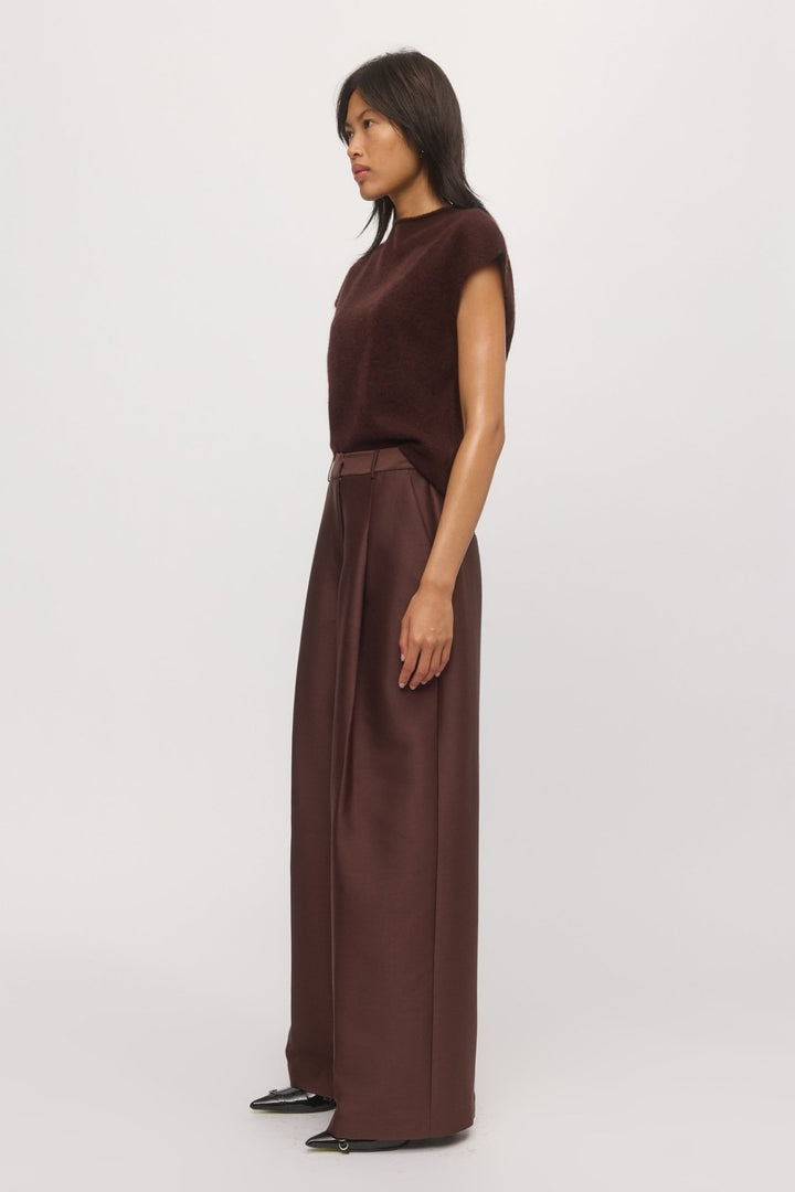 Side view of a woman is wearing knit tank in mahogany paired with wide-leg pants.