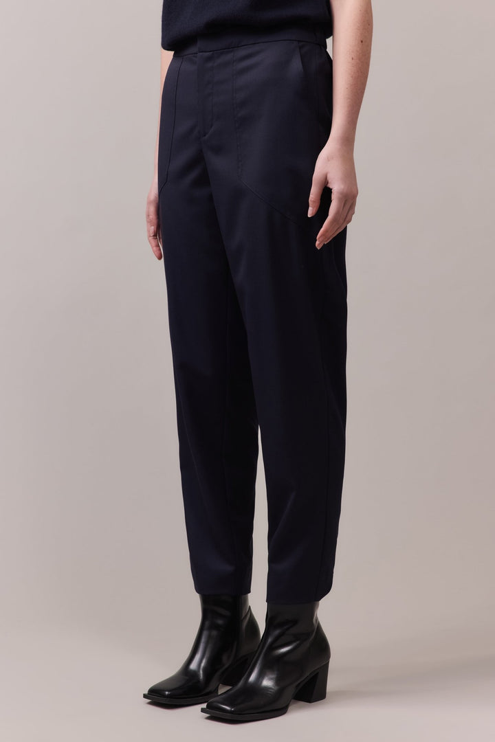 Side view showcasing the relaxed fit and angled front pockets, made from 100% wool for a refined, stylish look.
