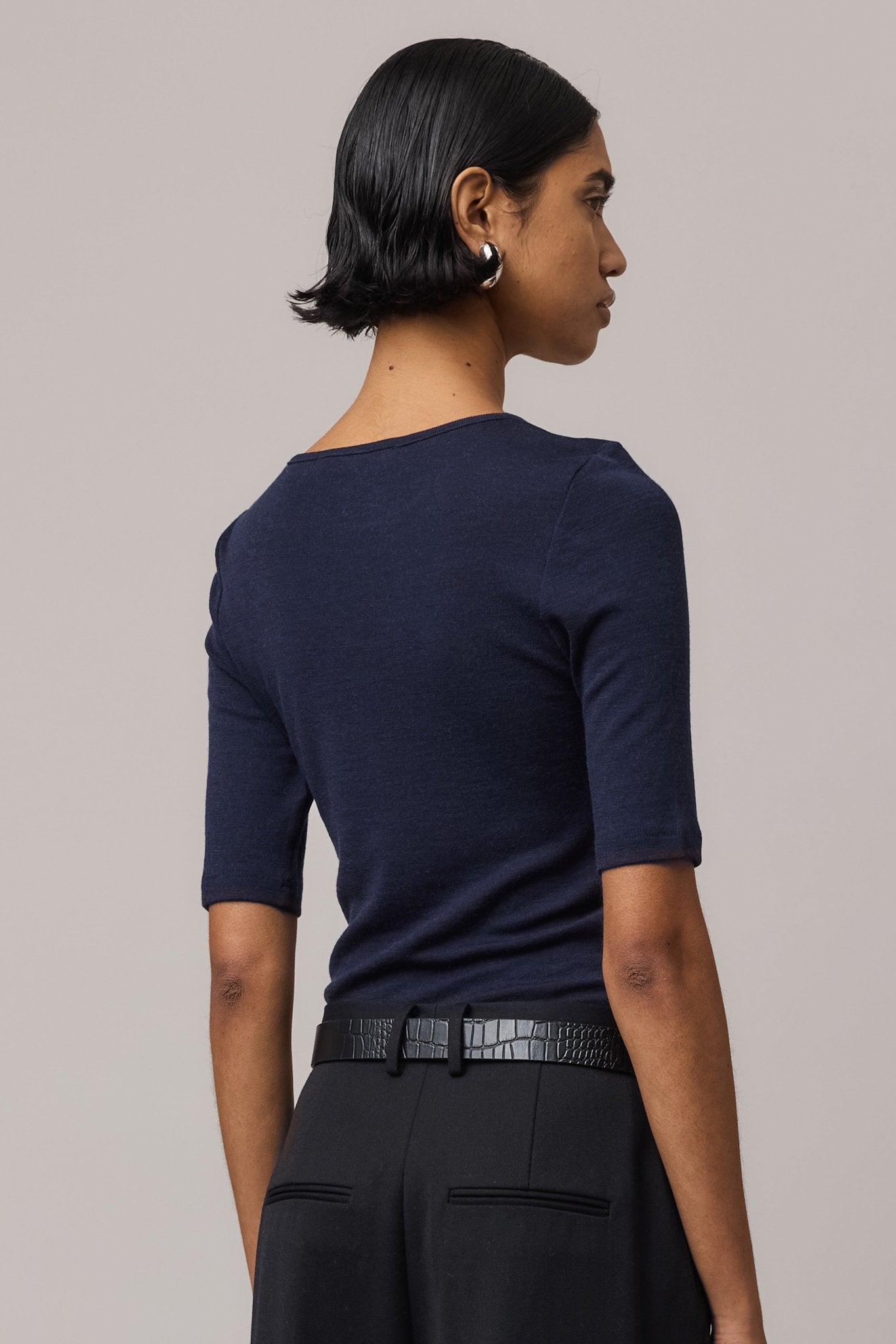 Close-up from behind of an indigo Merino Wool Crew Neck Tee, showcasing its soft texture and clean design.