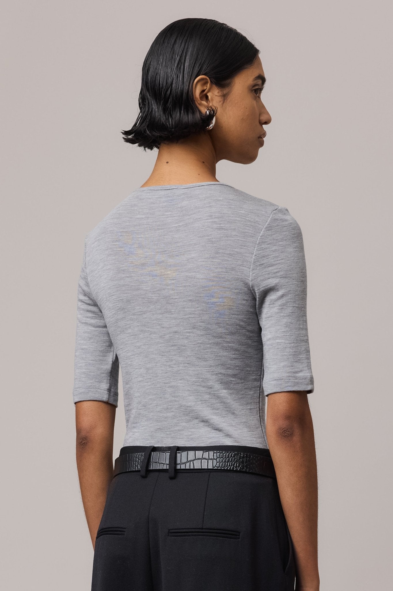 Close-up from behind of a grey Merino Wool Crew Neck Tee, showcasing its soft texture and clean design.