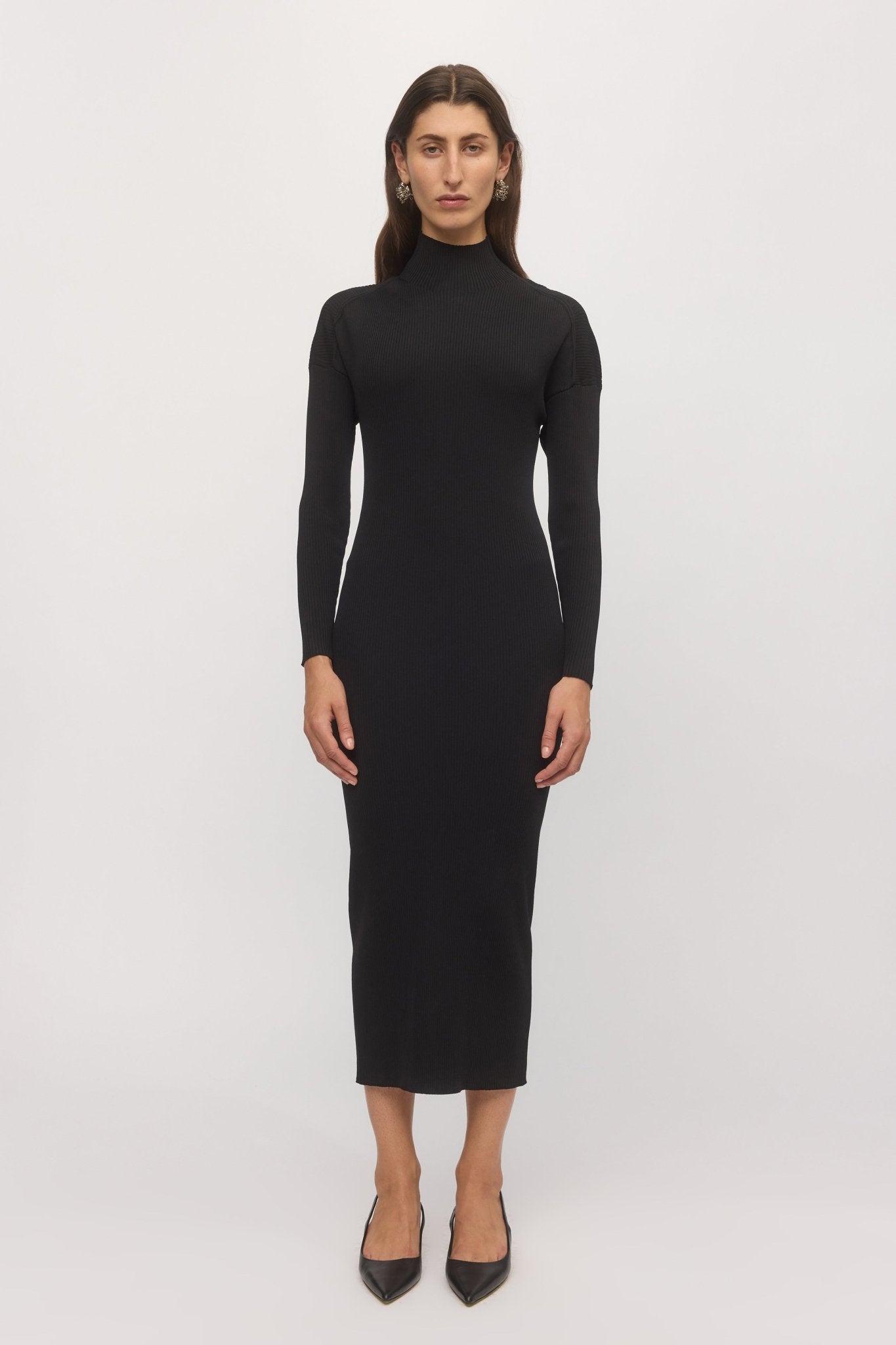 Front view of woman wearing Open Back Rib Dress in black with high neckline and slim-fit ribbed silhouette โ Skin and Threads