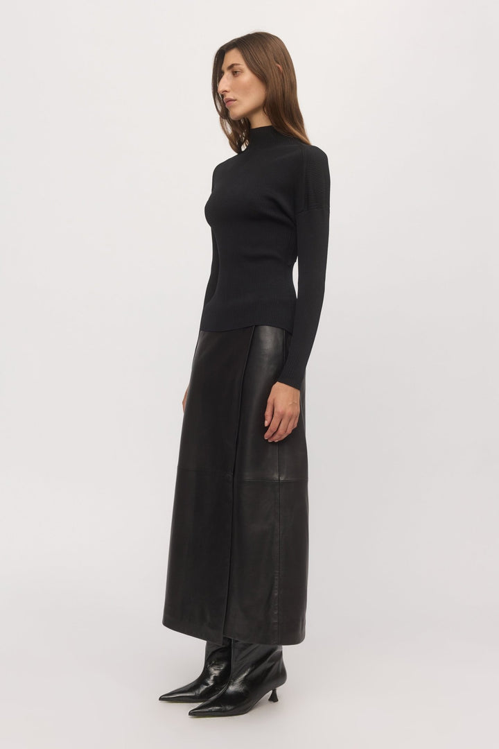 Side profile view of Open Back Rib Top styled with black leather maxi skirt and pointed boots – Skin and Threads