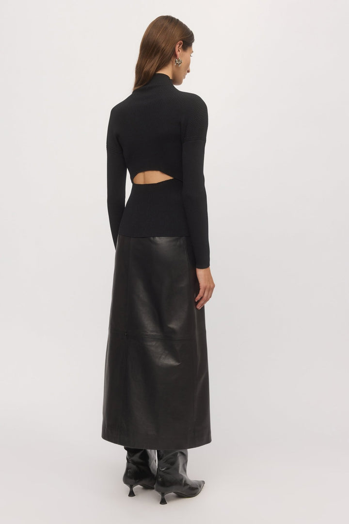 Back angled view of Open Back Rib Top showing waist cut-out and long sleeves styled with black skirt – Skin and Threads