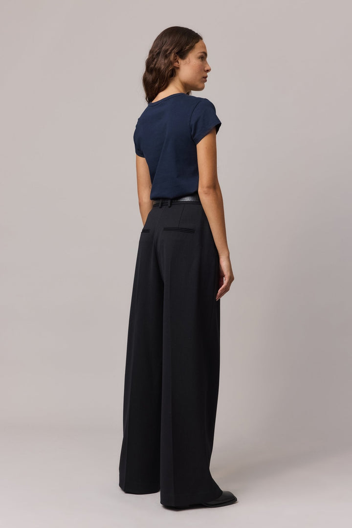 Back view of the woman wearing the indigo tee highlighting the classic cut and soft fabric.