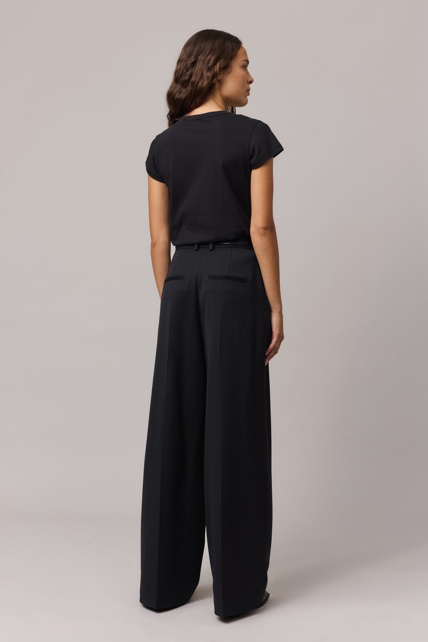 Back view of the black organic cotton tee, highlighting the simple yet elegant design.