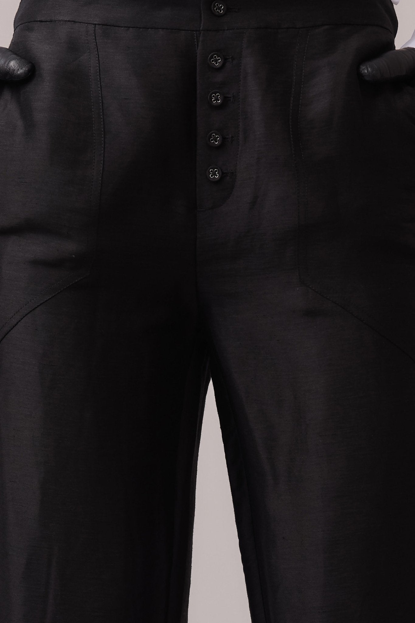 Woman wearing the Remi Silk Linen Pant with hands in the pockets, highlighting the deep front pockets and button fly detailing.