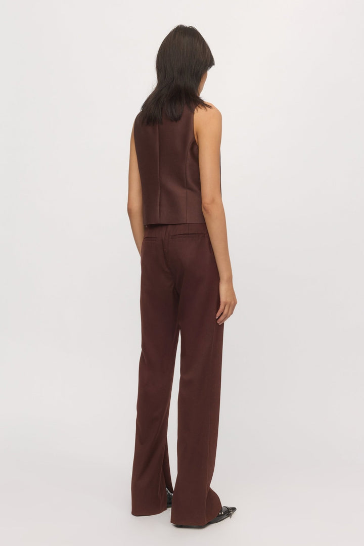 Back view of Split Leg Trouser in mahogany wool blend styled with sleeveless vest โ Skin and Threads