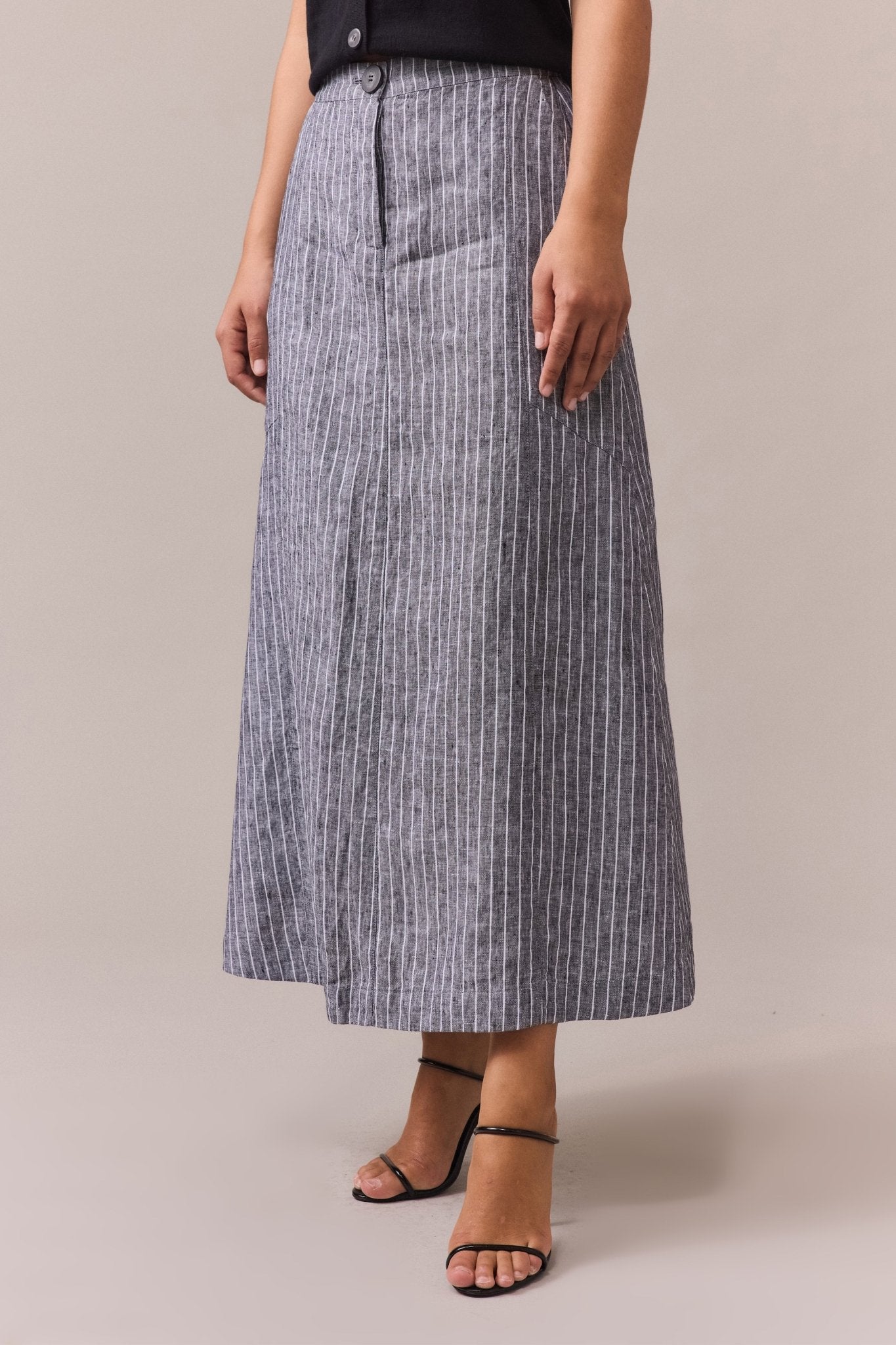  woman wearing a high-waisted, striped maxi linen skirt