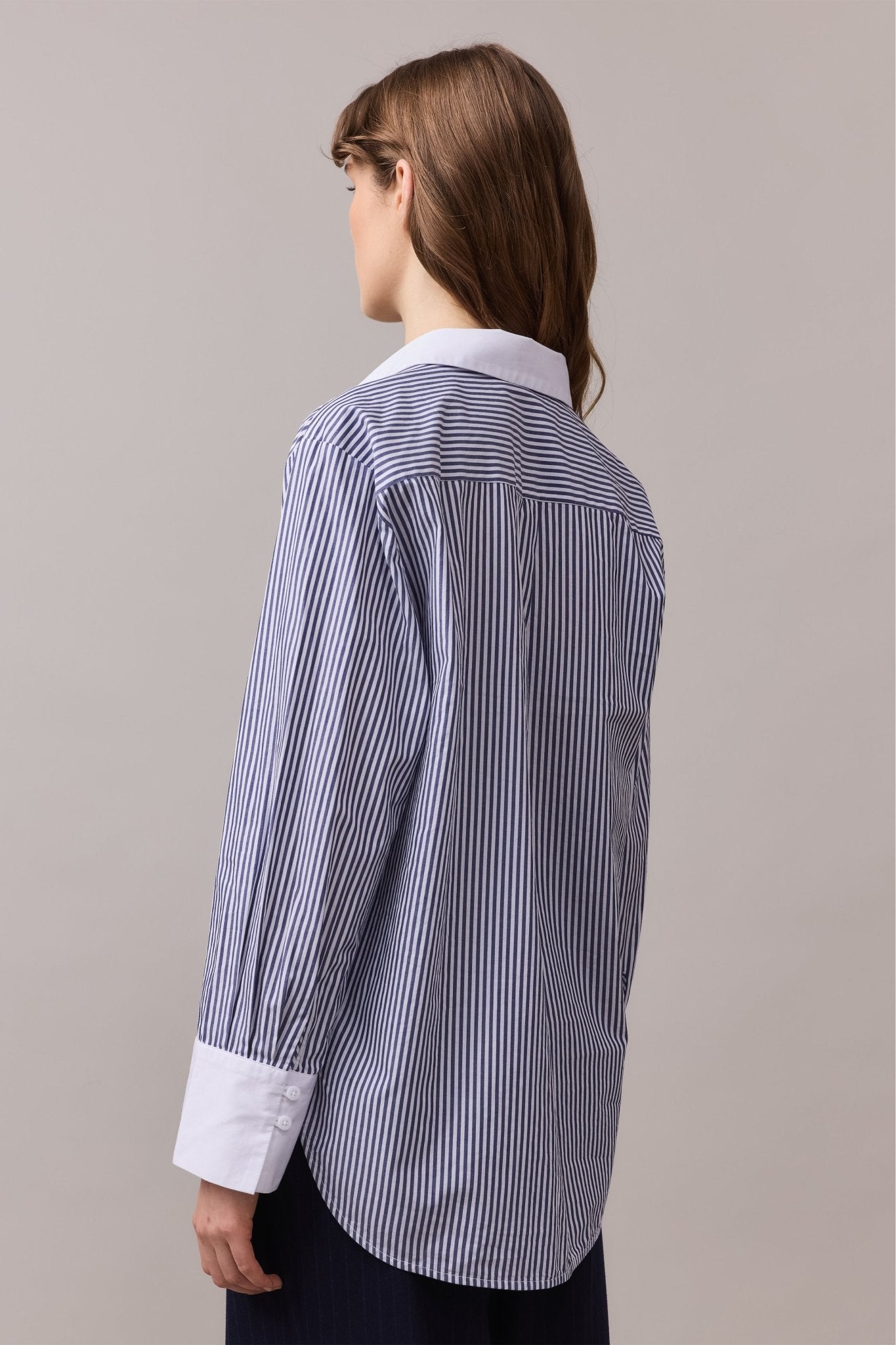 Close-up of the back of the Lenny Stripe Shirt, showcasing its relaxed fit, navy and white striped pattern, and neatly finished seams.