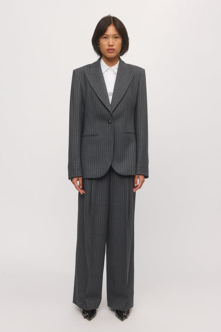 Woman wearing the Lola Wide Leg Pant in graphite stripe with the matching tailored blazer and white shirt. - Skin and Threads