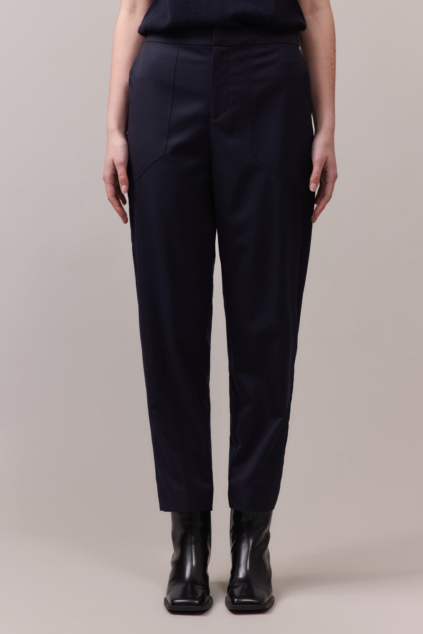 Front view of the navy Marlow Casual Pant for women, crafted from soft, lightweight wool with a tailored waistband and elastic back for comfort.