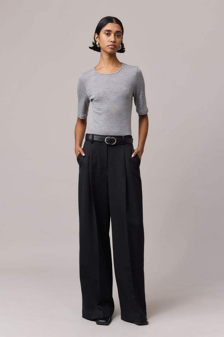 Woman wearing a grey Merino Wool Crew Neck Tee with elbow sleeves. The classic t-shirt fit is crafted from 100% fine Australian Merino wool.
