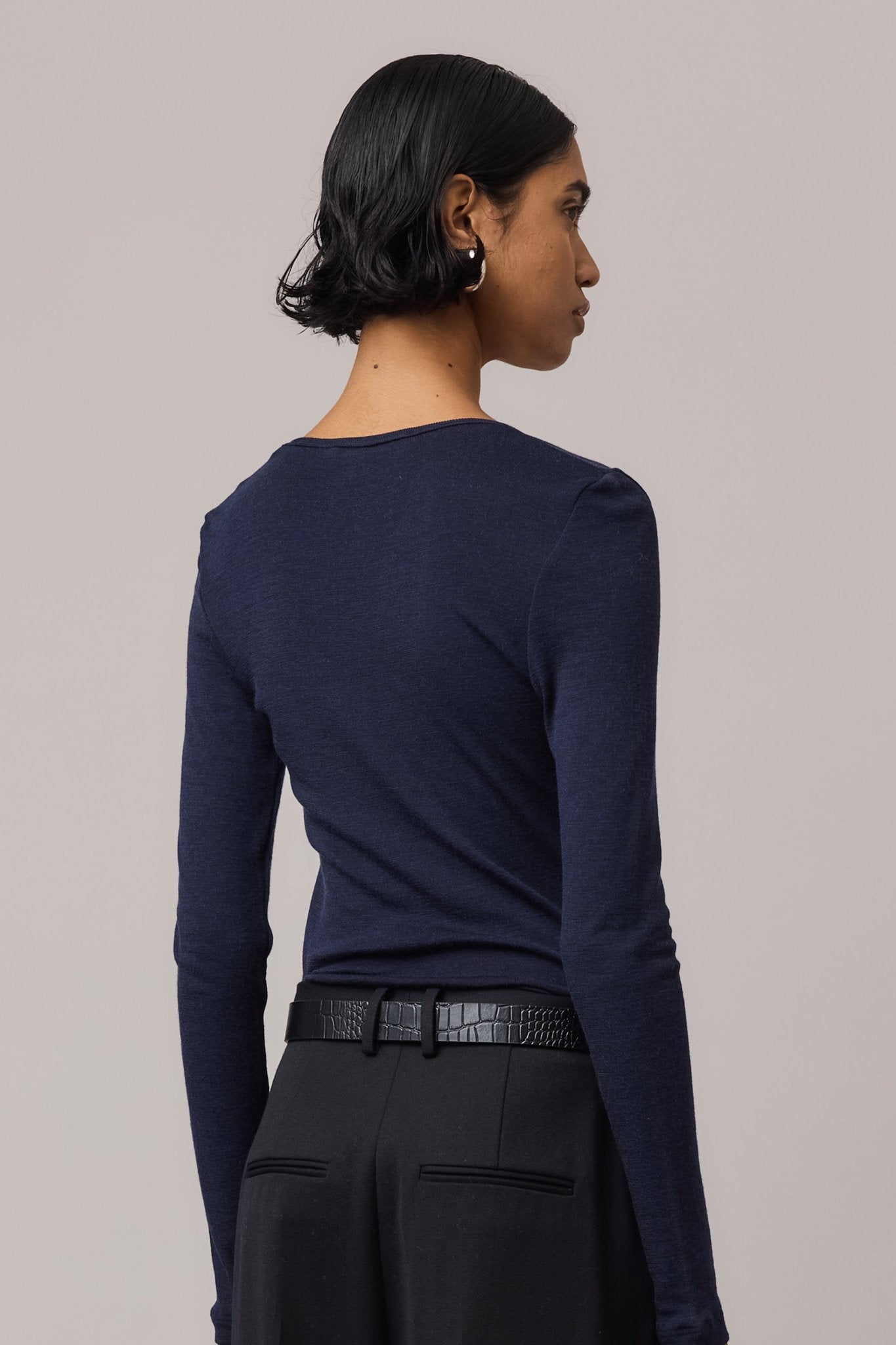 Close-up from behind of an indigo Merino Wool V Neck Top, highlighting its soft texture and clean lines.