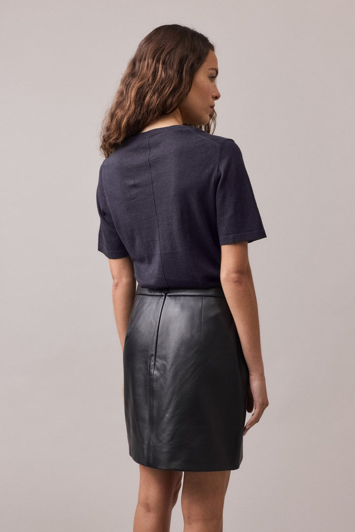 Close-up view of the back of the navy Nara Knit Tee, highlighting the fine ribbed collar, hem, and cuffs.