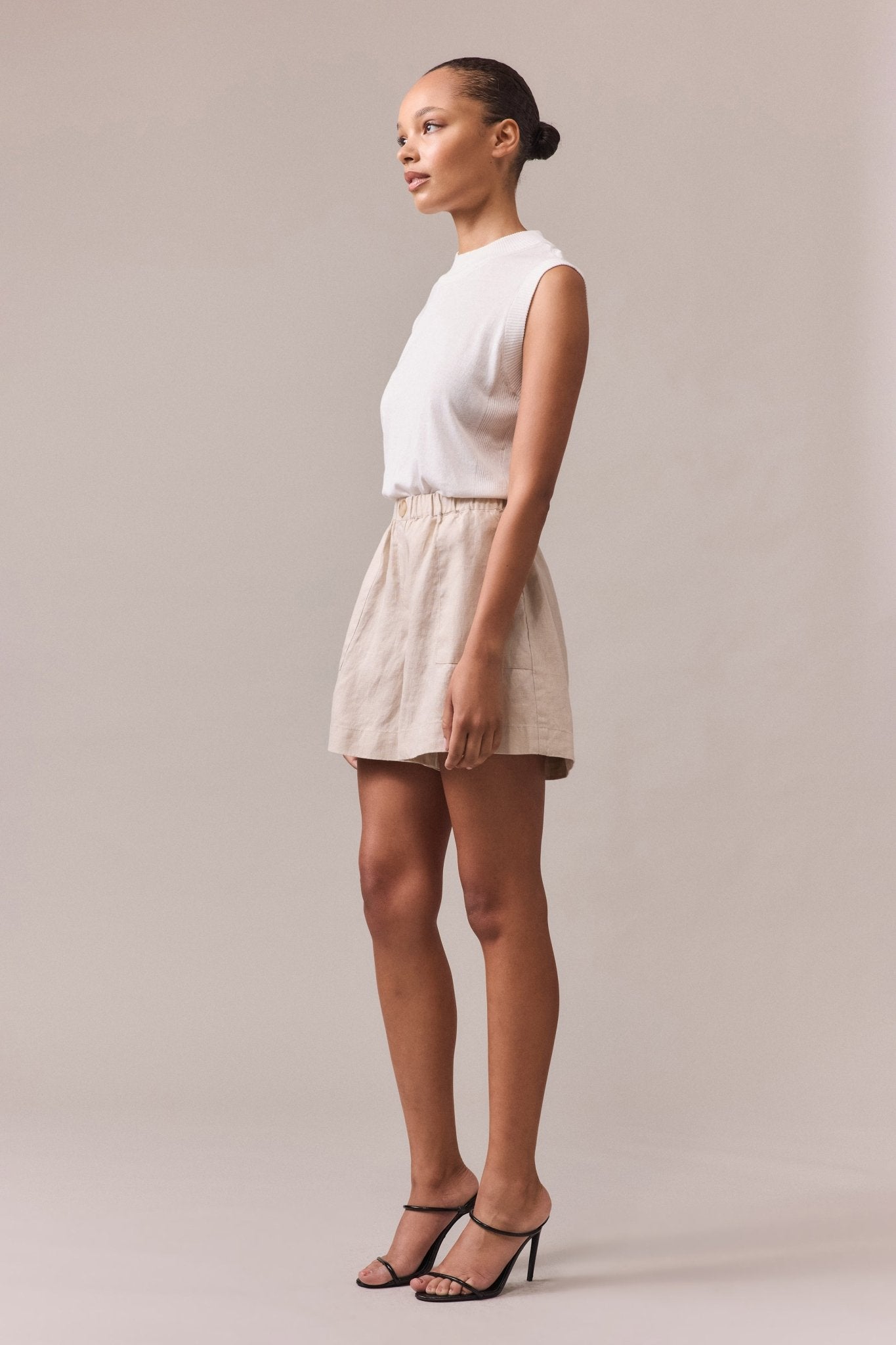 Side view of the women's linen shorts, showcasing the feature button and lightweight linen fabric.