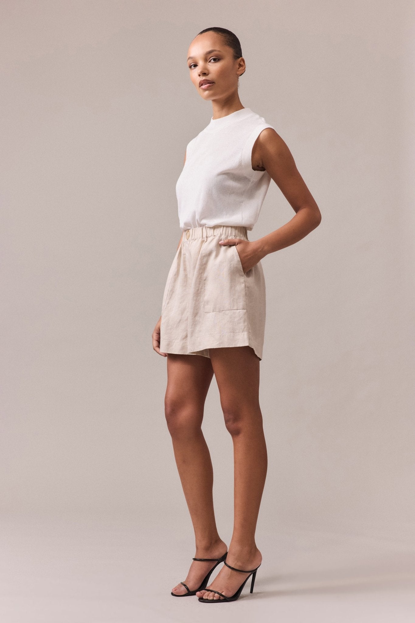 Rear angle of the sand women's linen shorts, showing the elasticated waist and comfortable fit.